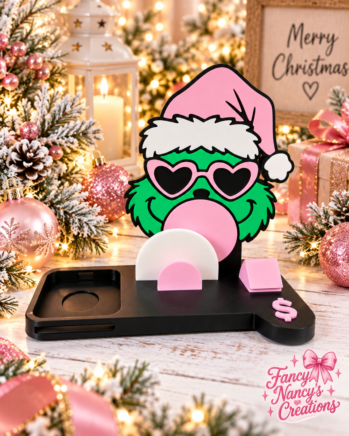 3D printed Grinch pay stand with pink Santa hat, heart-shaped glasses, bubblegum detail, and black tray base with pink accents.