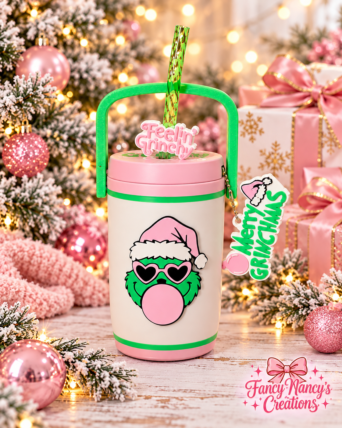 White Grinch cooler with pink lid and base, green carry handle, Feelin' Grinchy straw topper and Merry Grinchmas accessory.